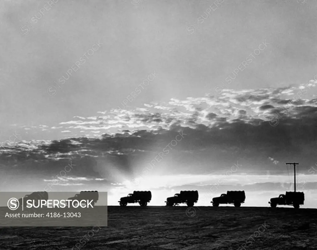 1940S Line Of Military Trucks At Sunset