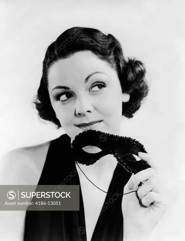 1930S Portrait Of Woman In Evening Dress Holding Party Mask