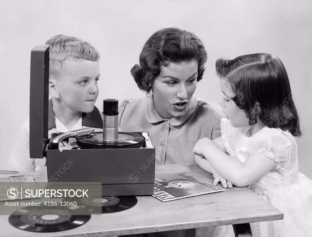 1950S Mother Daughter & Son Listening To 45'S On Portable Record Player