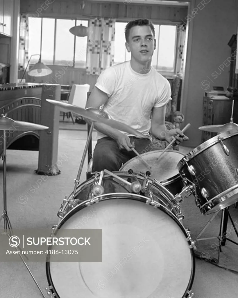 1960S Teen Boy With Buzz Cut In T-Shirt Sitting In Front Of Small Drum Kit Holding Sticks Over Snare