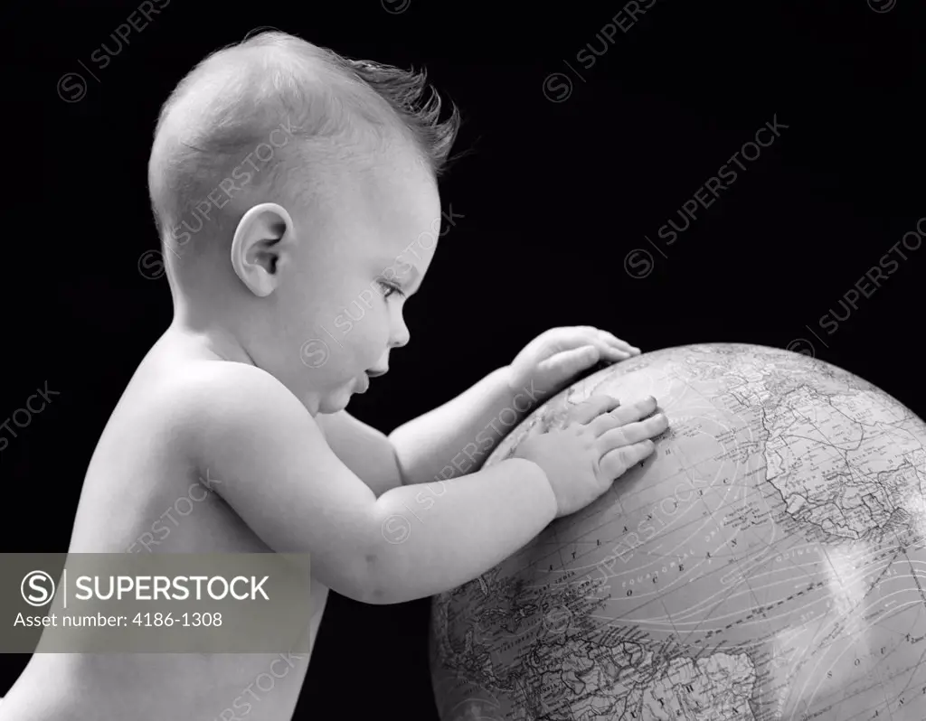 1940S Baby With Hands On Globe Looking At The Earth