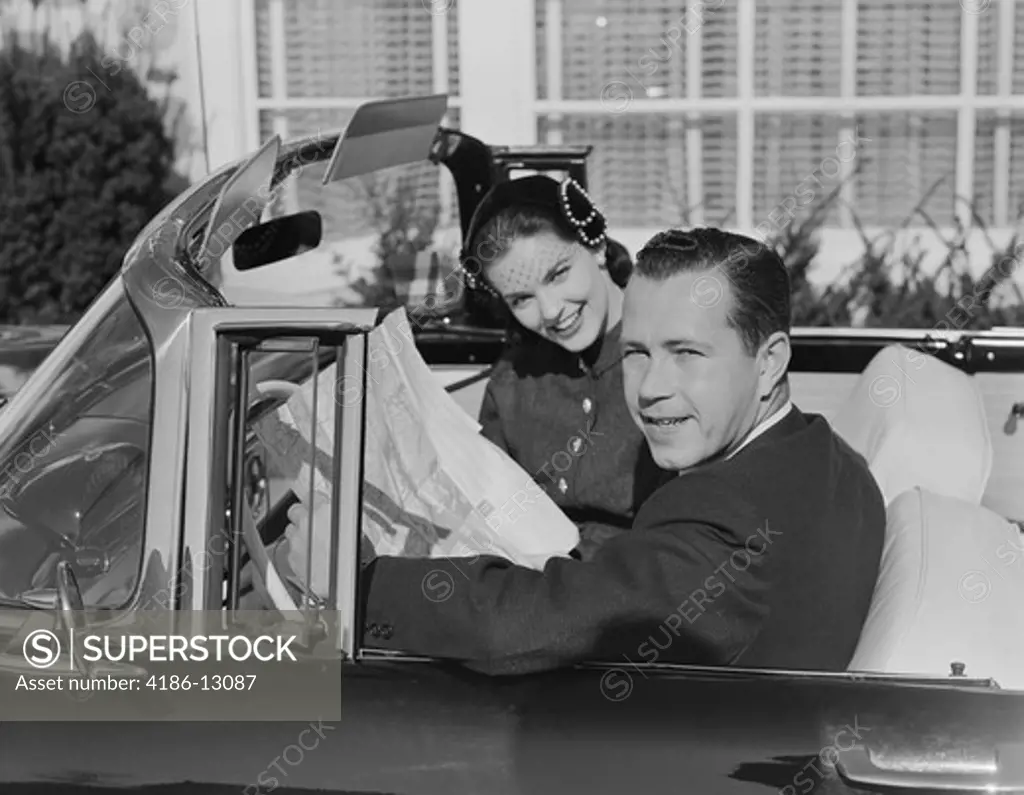 1950S Husband Wife Man Woman In Automobile Reading Map 