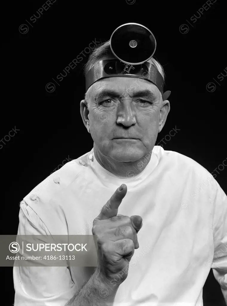 1940S 1950S Portrait Man Doctor Wearing Examination Mirror Pointing Shaking Finger Giving Stern Warning