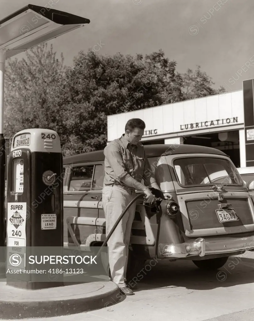 1950S Service Station Attendant Man Filling Gas Tank Of Wood Body Station Wagon Automobile
