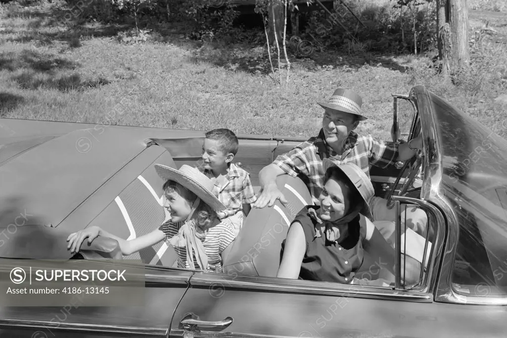 1960S Family Of Four In Convertible Looking Towards Left