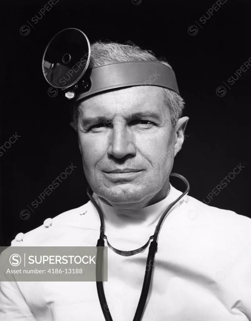 1940S Portrait Of Senior Doctor Wearing Opthalmoscope And Stethoscope