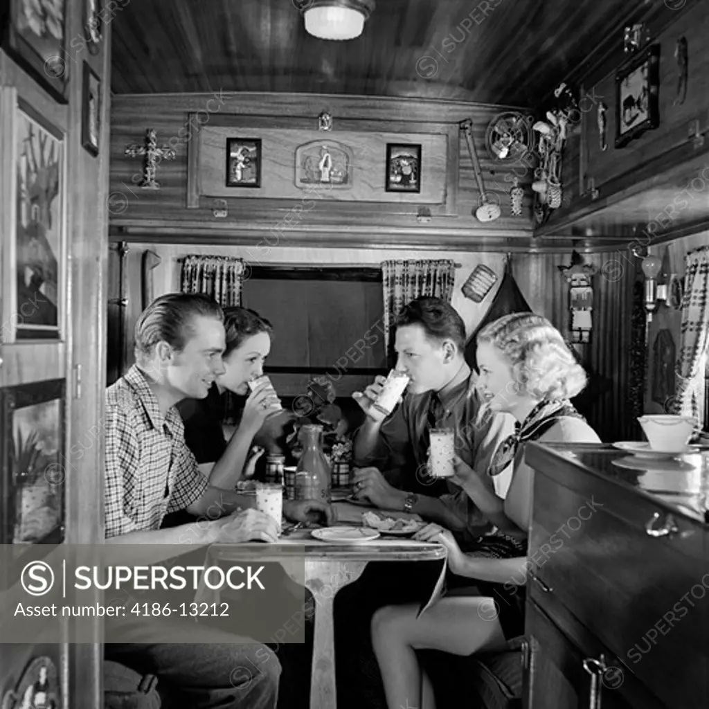 1930S Two Couples Sitting Inside Camping Trailer Eating Lunch