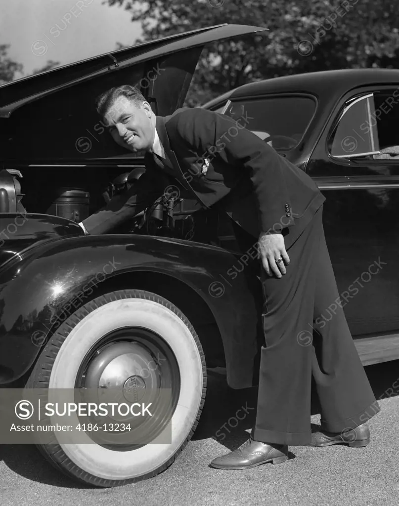 1939 1940S Smiling Man Wearing Suit And Tie Checking Engine Under Automobile Hood