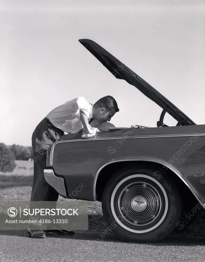 1960S Side View Of Man In Shirt & Tie Looking Under Hood Of Car Pulled Up On Side Of Road