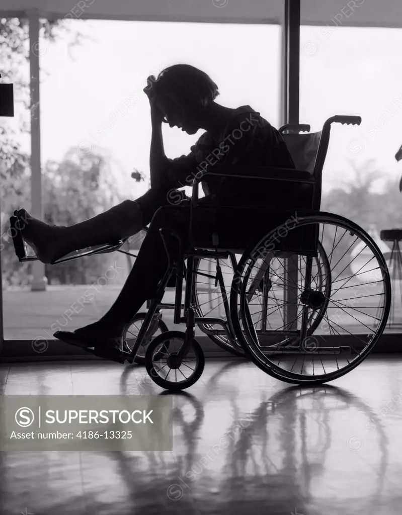 1960S Silhouette Of Woman In Wheelchair With Leg Propped Up In Cast & Holding Hand On Forehead