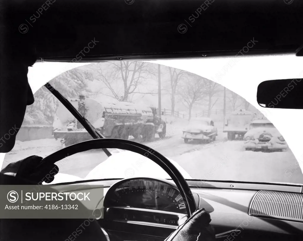 1950S Silhouette Of Man Driving Automobile In Snow Storm Windshield Wiper Pattern 