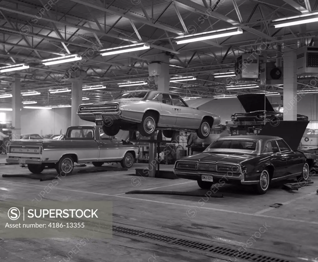 1960S Large Garage With Pickup & 2 Cars Car In Middle Jacked Up By Hydraulic Lift