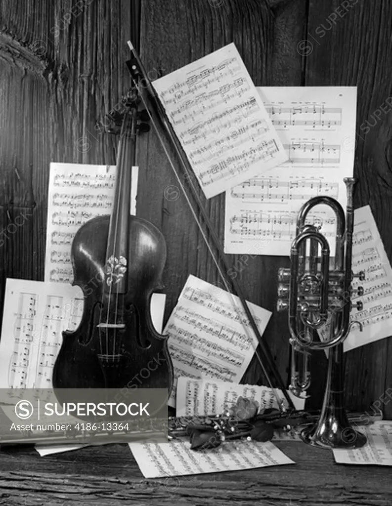 Still Life Of Violin Flute Trumpet & Roses On Background Of Wood & Sheet Music