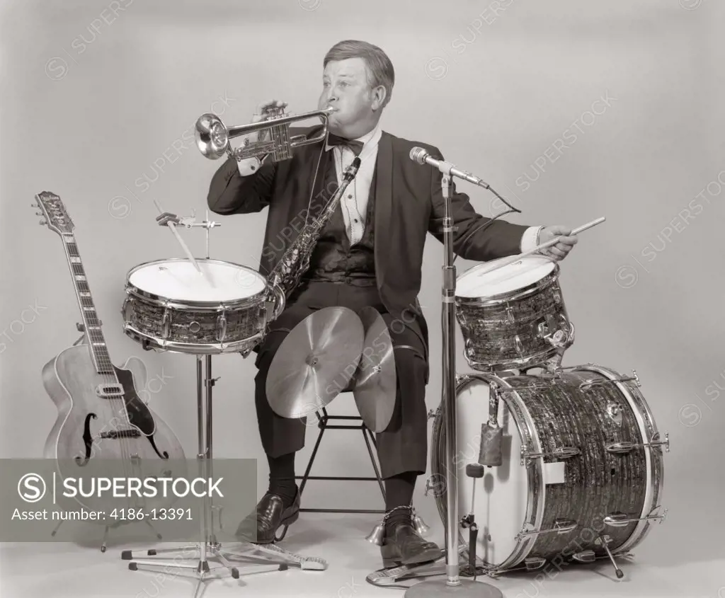 1970S One-Man Band Man In Tuxedo Blowing Trumpet In One Hand Playing Drum With Other Base Drum With Foot Cymbals Between Knees