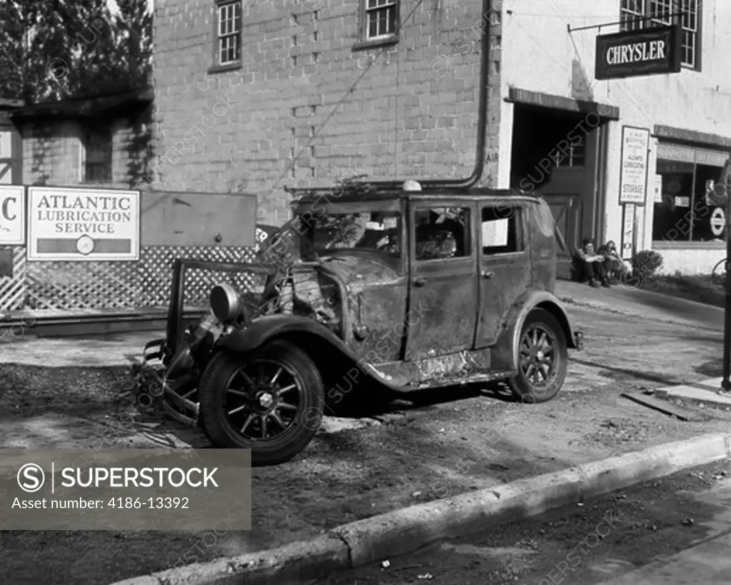 1920S Wrecked Car Sitting On Sidewalk Next To Mechanic'S Shop