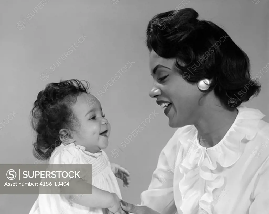 African-American Mother Smiling At Baby Studio