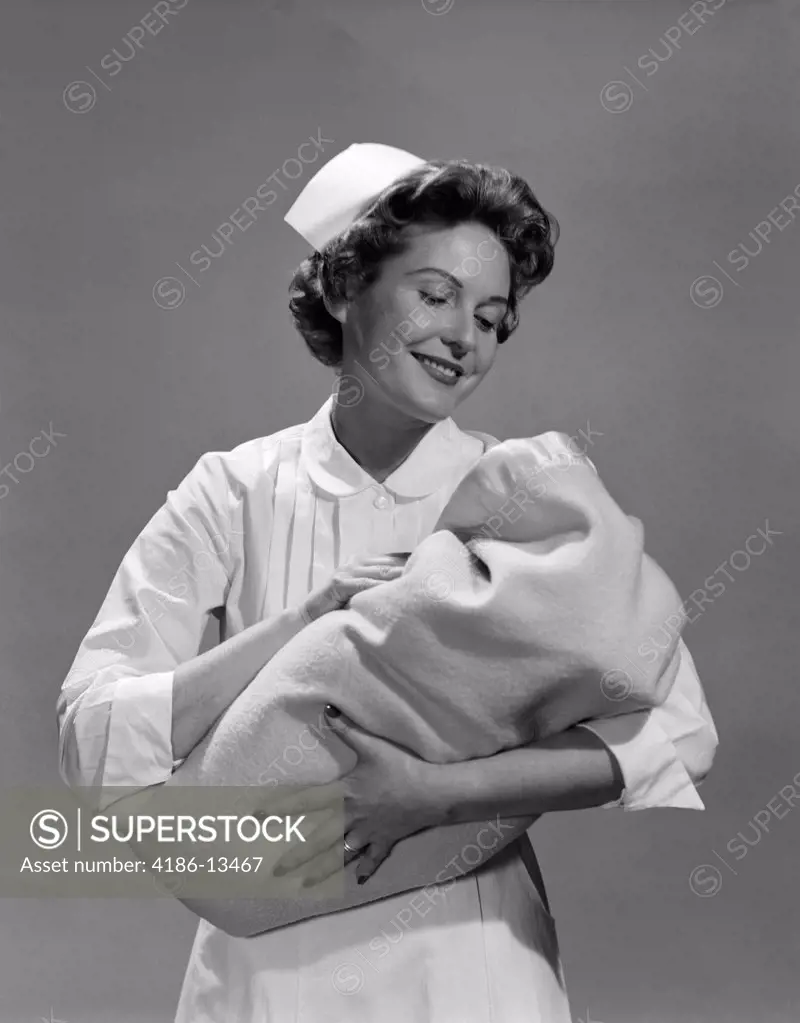 1950S Nurse Holding Newborn Infant Wrapped In Blanket