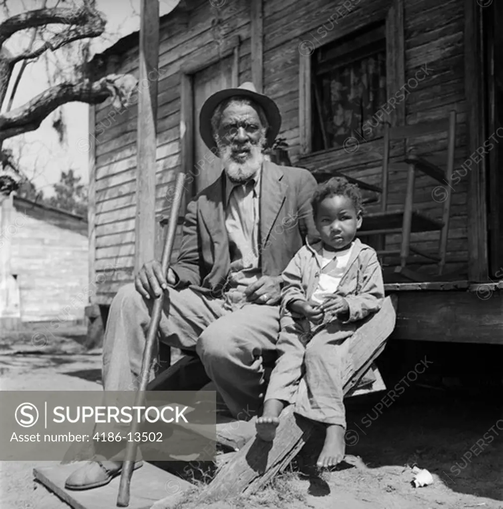 1930S Elderly Man Grandfather Sit Porch Shack With Grandson Boy