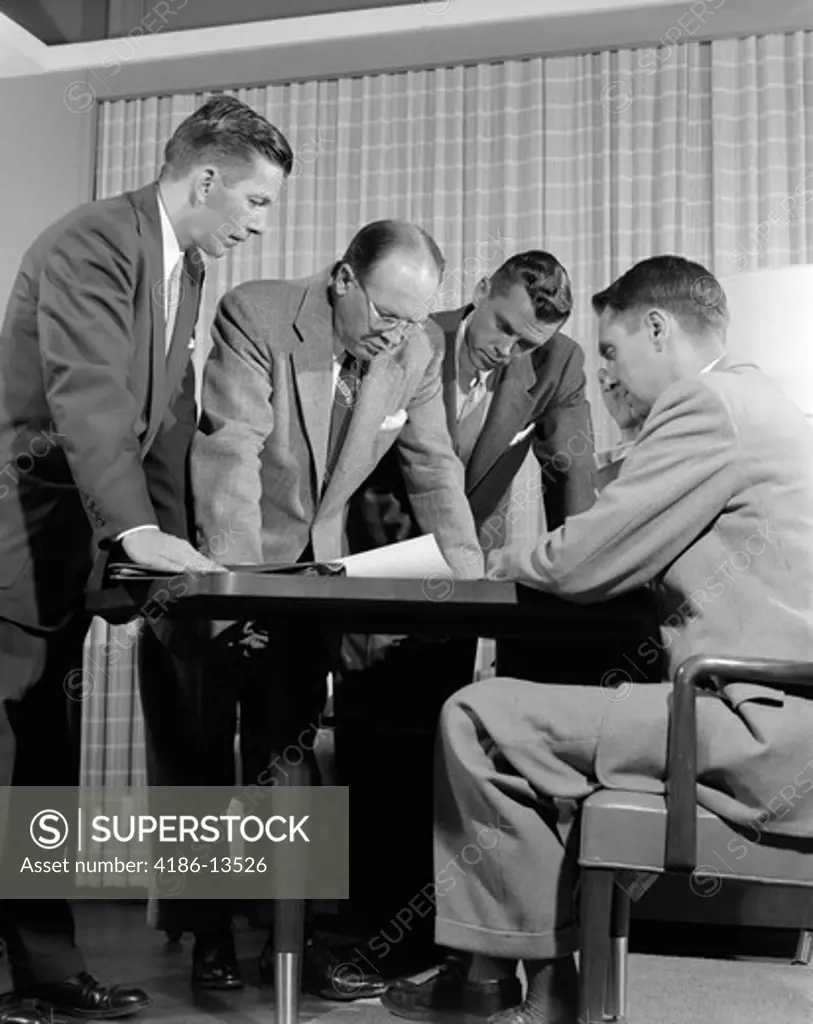1950S Group Of Men Businessmen Looking At Plan On Desktop In Office Indoor