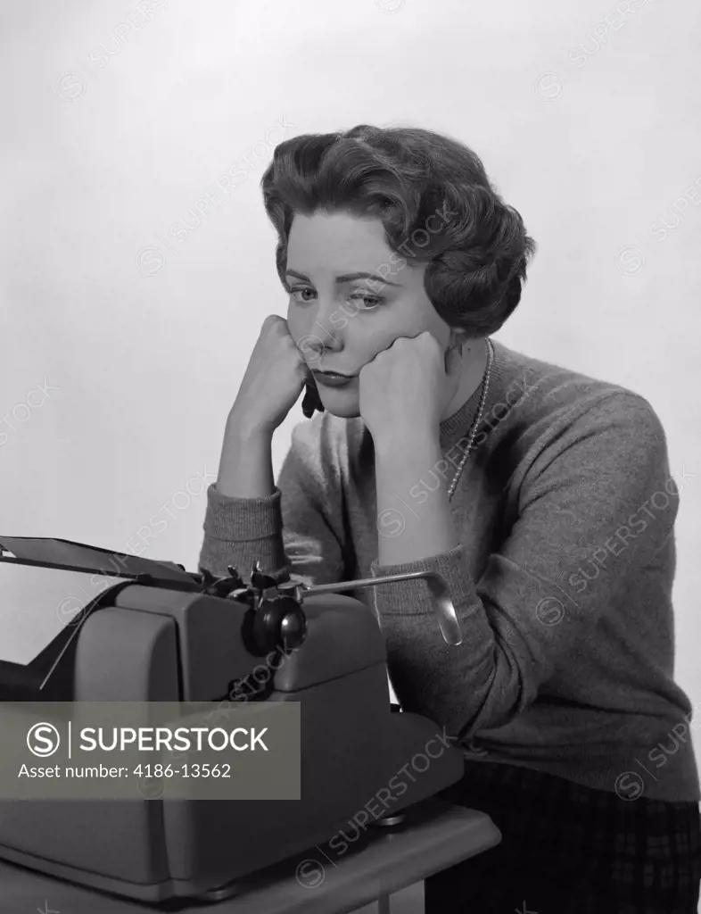 1960S Depressed Secretary Sitting At Business Typewriter