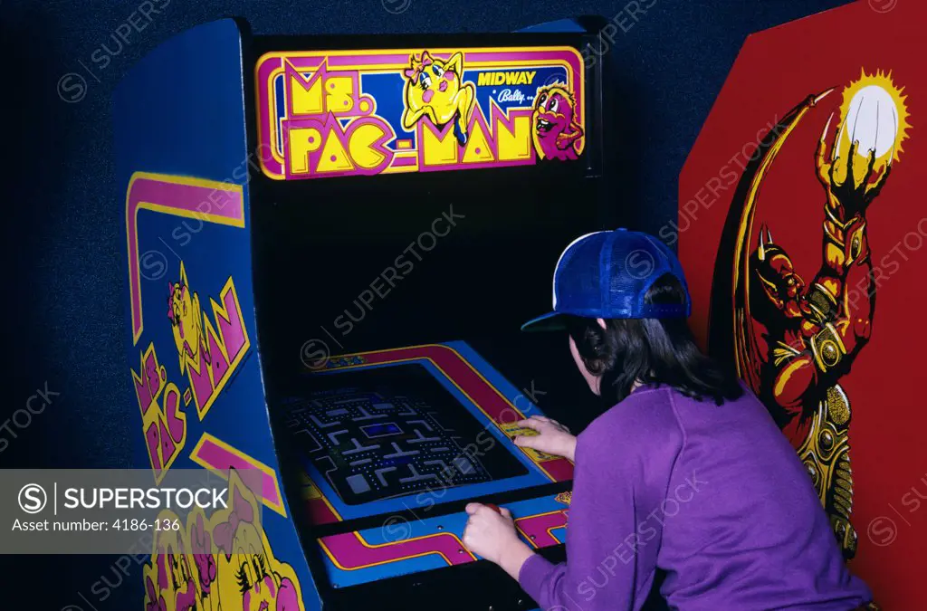 1980S Teen Girl Wear Baseball Cap Playing Ms Pac Man Video Game In Arcade