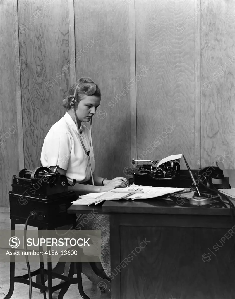 1930S Woman Secretary At Business Office Deck Transcribing From Dictaphone Dictation Voice Recording Machine