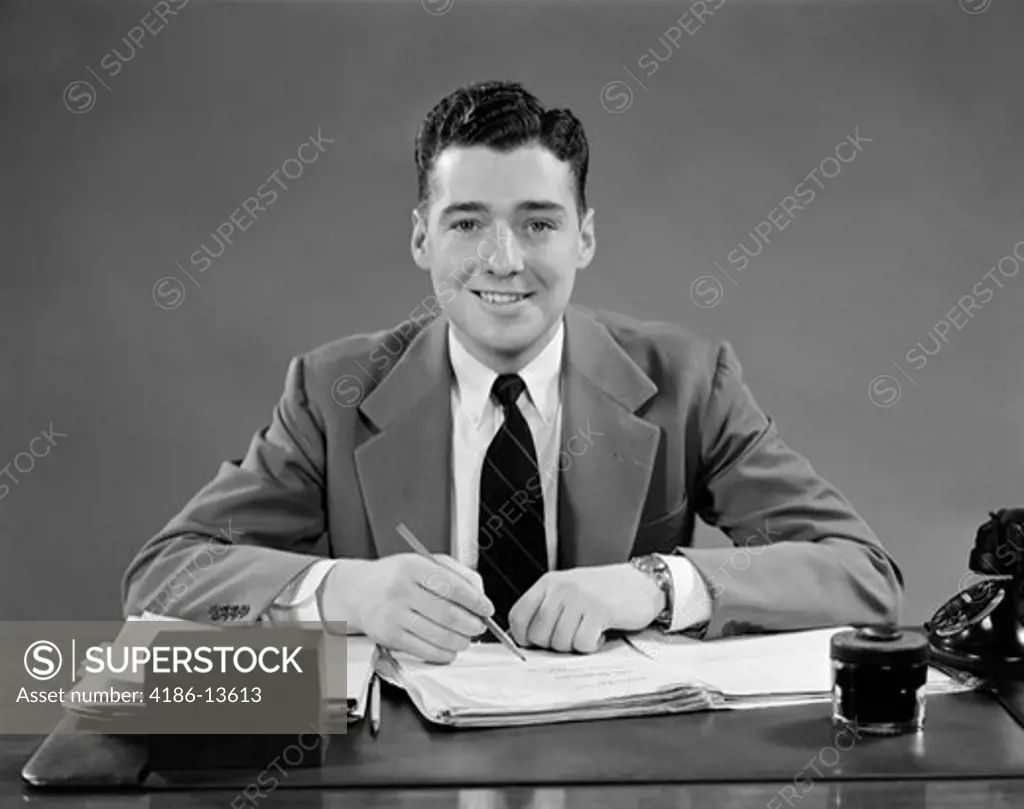 1940S Man Sitting At Desk In Office