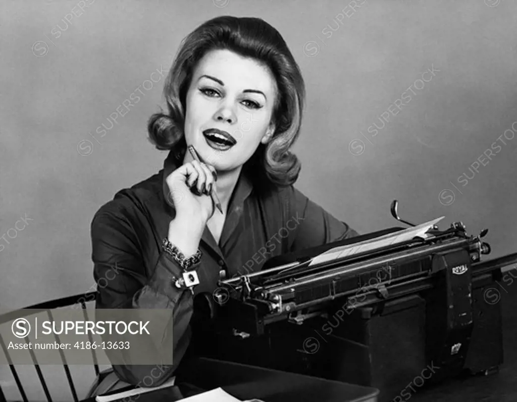 1960S Woman Secretary Smiling At Camera Seated At Desk Typewriter Charm Bracelet On Wrist