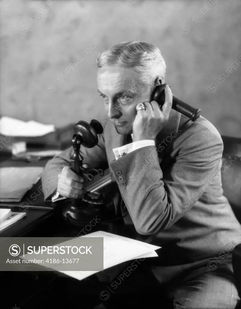 1920S Businessman At Desk Talking On Candlestick Phone