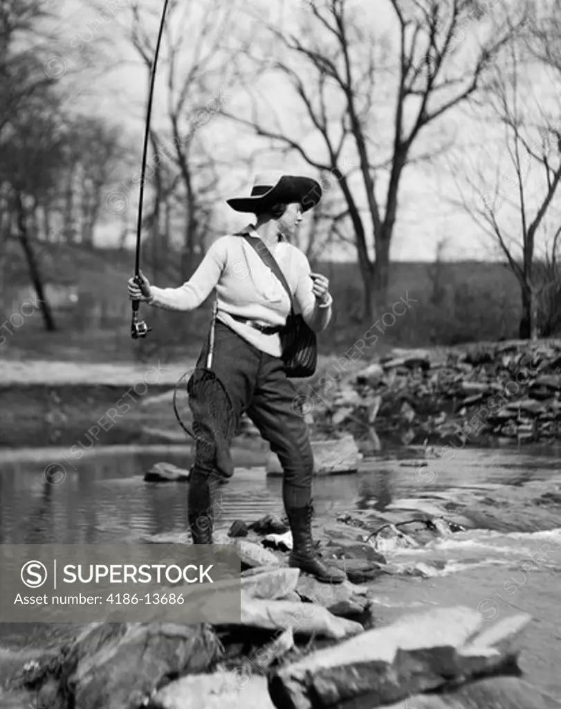 1920S Woman In Hat With Fishing Net & Tackle Bag Strapped To Her Casting Line Out Into Creek