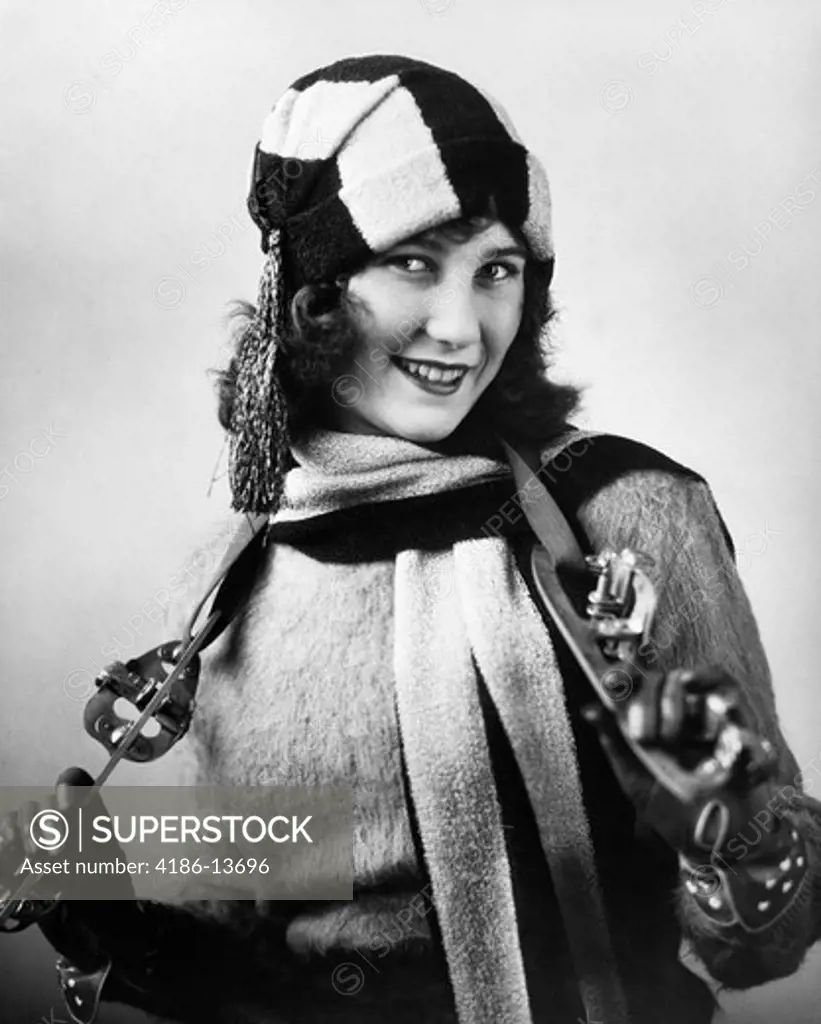 1920S Woman Wearing Sweater Scarf & Hat With Strap-On Ice Skates Hanging Around Neck