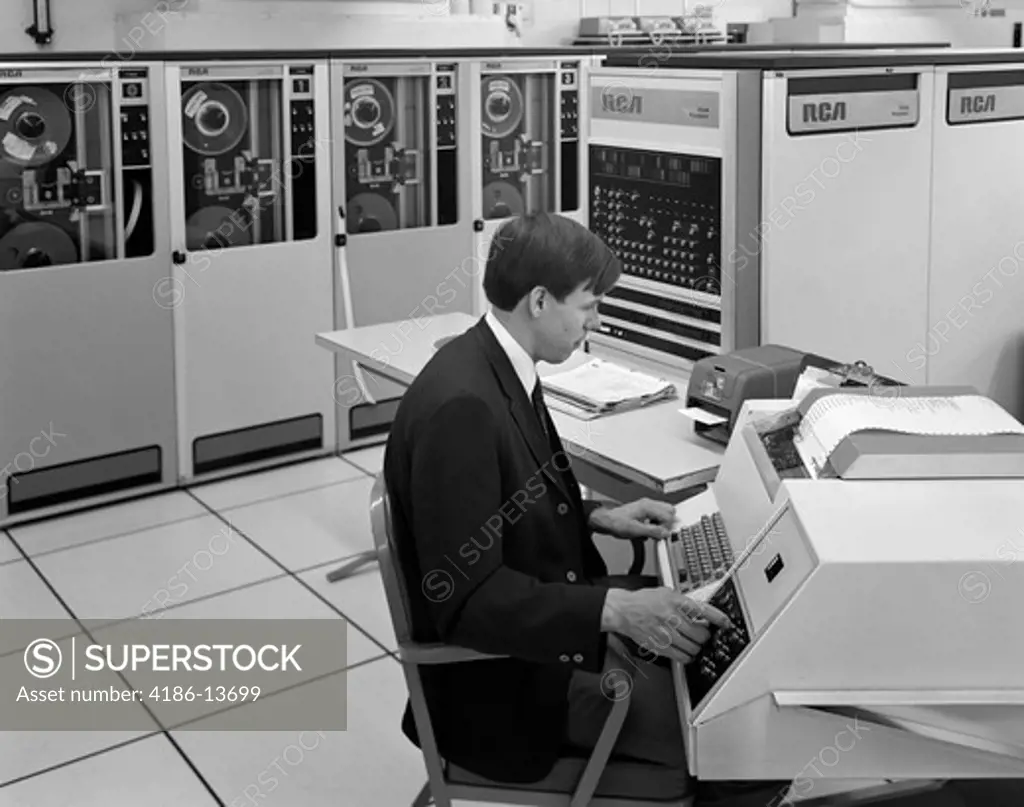 1960S Side View Of Man In Jacket & Tie Operating Large Computer Terminal