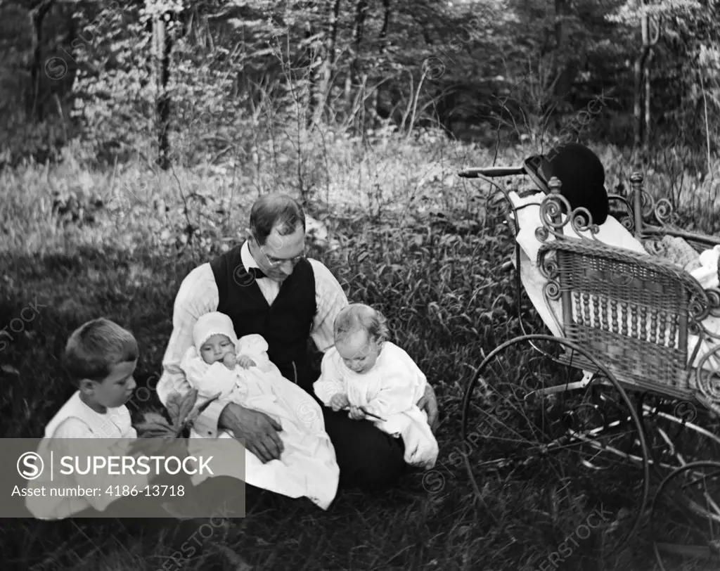 1890S 1900S Turn Of The Century Father Sitting In Woods With Three Children Baby Carriage Off To Side