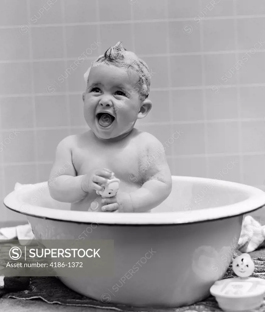 1940S Smiling Baby In Bath Covered In Soap Suds Laughing Holding Toy