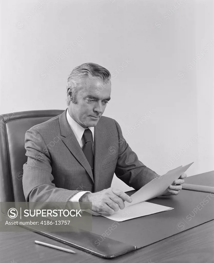 1970S 1960S Businessman Executive Middle Aged Sitting At Desk Reading Papers