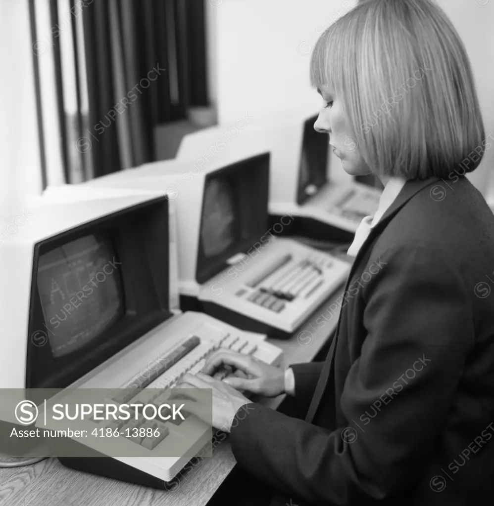 1980S Woman In Office At Keyboard From Behind