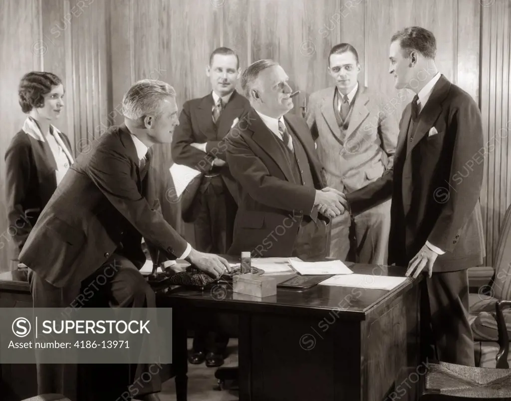 1930S 1930 Businessmen Meeting Handshake Office Men Women Executive Smoking Cigar Smiling Standing Around Desk Success Indoor