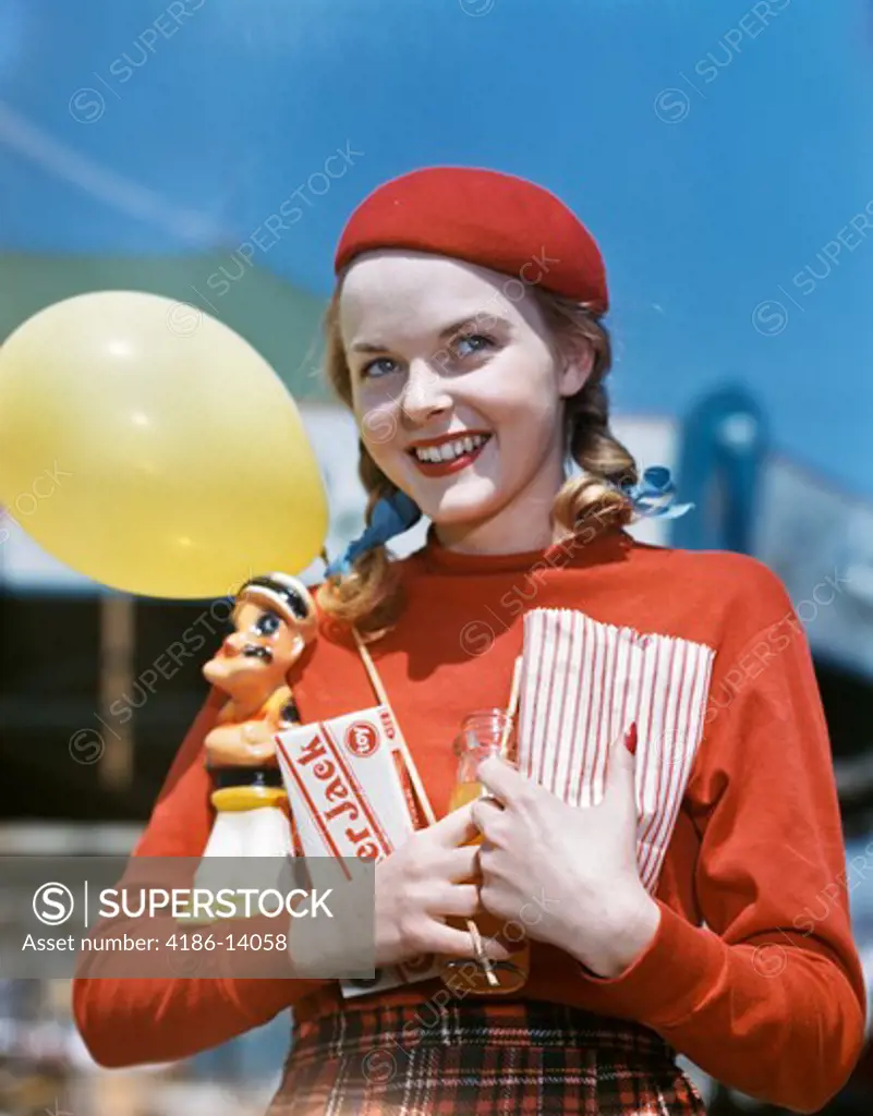 1940S 1950S Smiling Teen Girl Holding Popeye Amusement Park Prize Cracker Jack Box Yellow Balloon Wearing Red Tam
