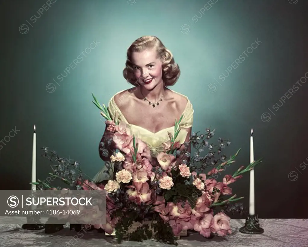 1950S Smiling Woman Wearing Formal Gown Arranging Flowers Centerpiece On Dining Table