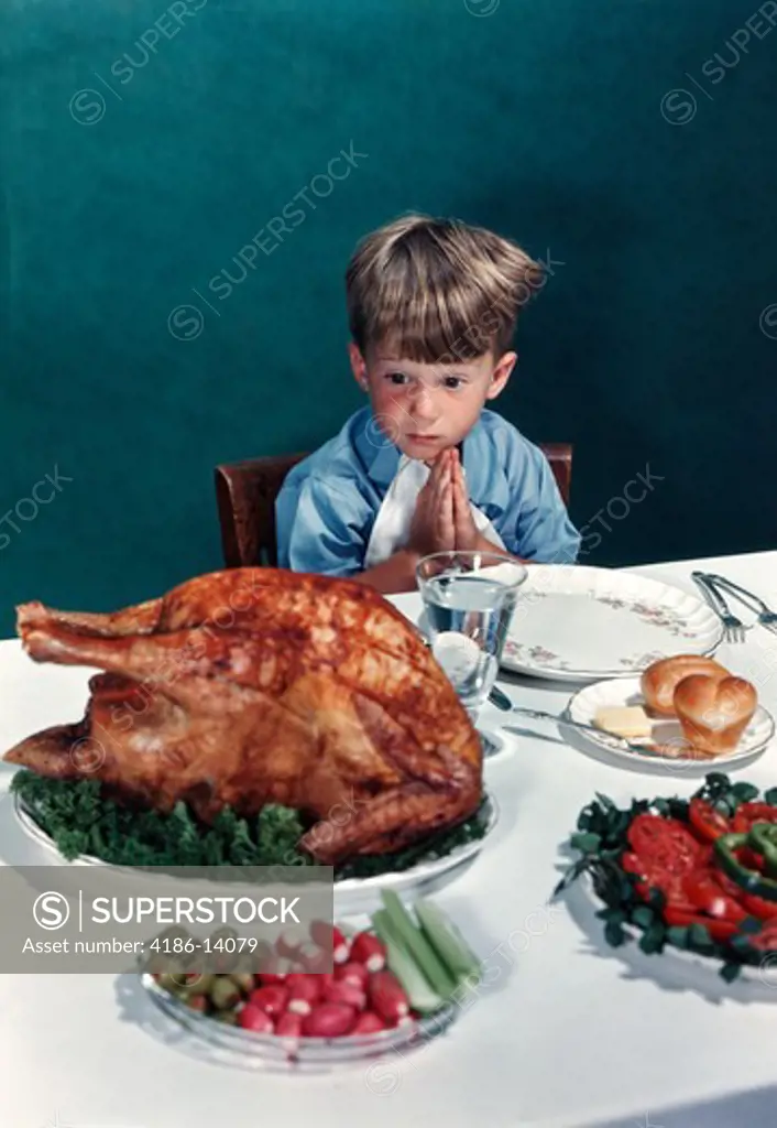 1940S 1950S Little Boy Staring At Thanksgiving Turkey While Saying Prayer Grace