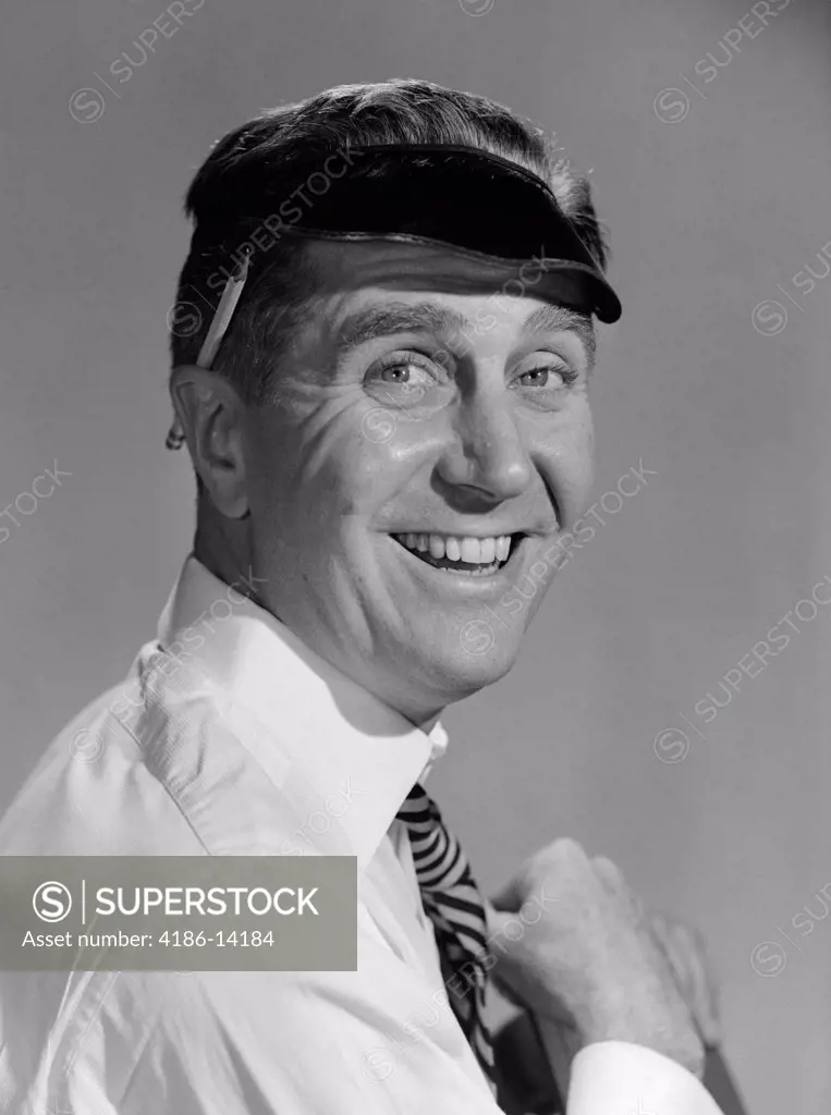 1950S Portrait Man Accountant Smiling Wearing Eye Shade Visor With Pencil Behind Ear Studio Indoor