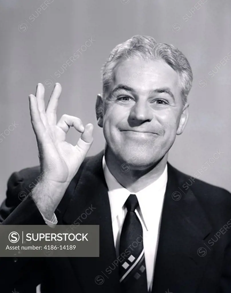 1950S Portrait Of Happy Smiling Man Businessman Salesman Making An Ok Hand Sign