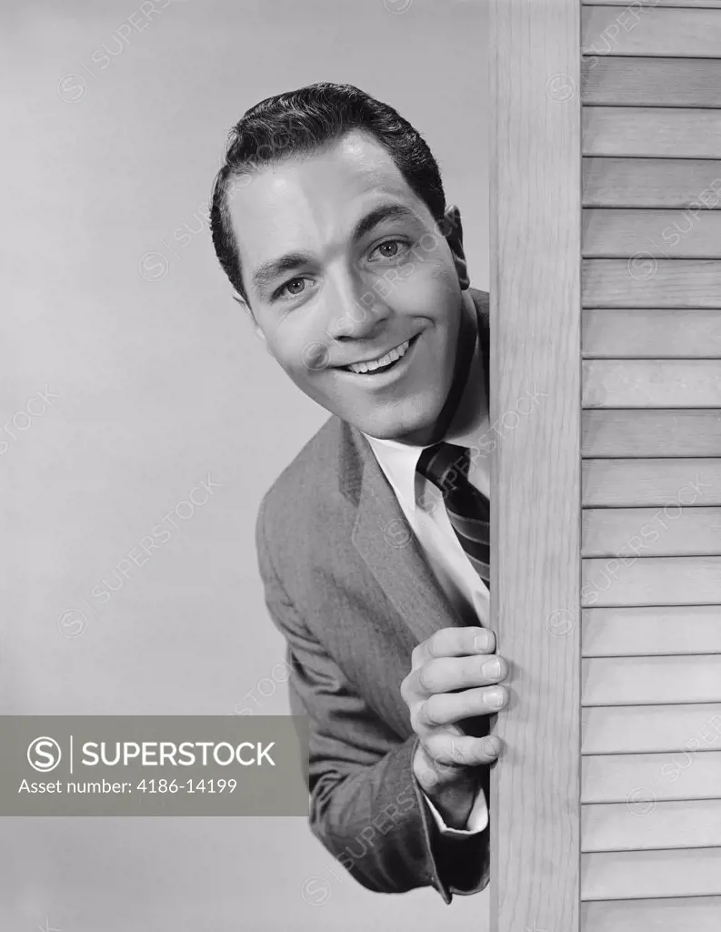 1960S Smiling Man Business Suit Peeking From Behind Louvered Door