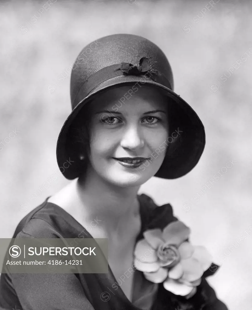 1930S Head & Shoulders Portrait Of Smiling Woman Wearing Hat & Flower On Blouse