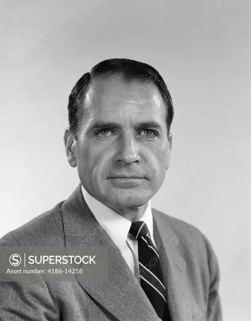 1960S Head Shoulders Of Middle Aged Man Wearing A Business Suit Tie With A Serious Stern Business Like Facial Expression