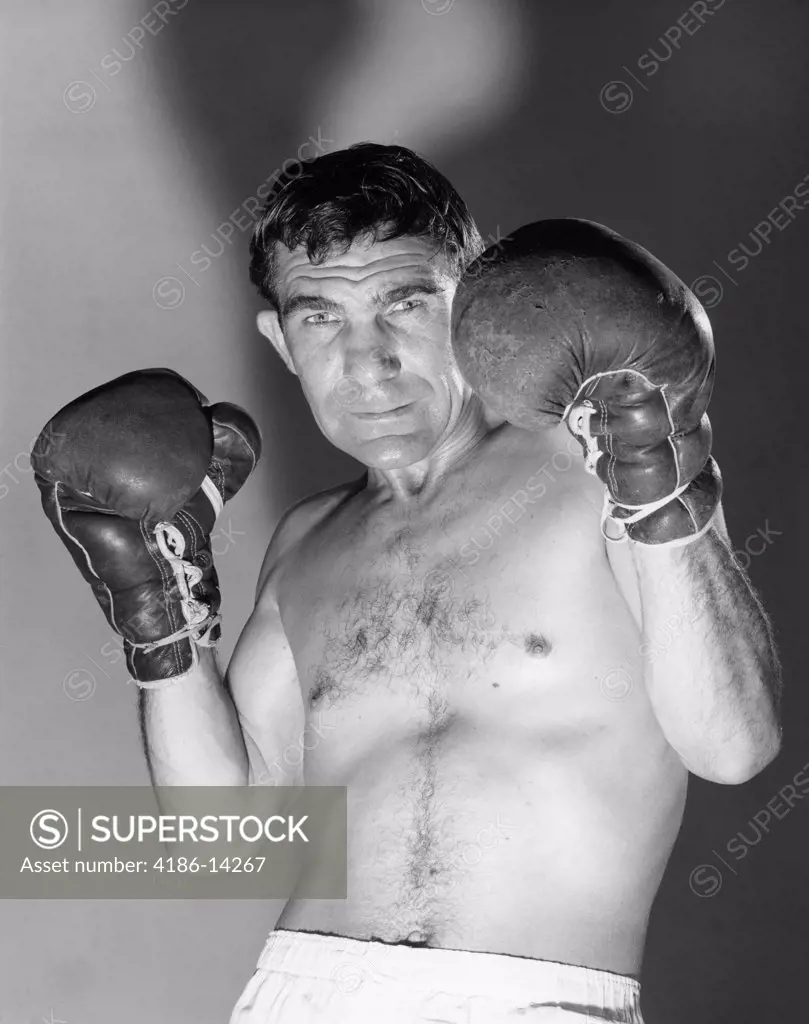 1960S Portrait Of Boxer Holding Gloved Hands Up To Protect Face