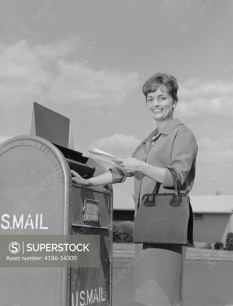 1960S Smiling Woman Dropping Letters In Postal Mail Box