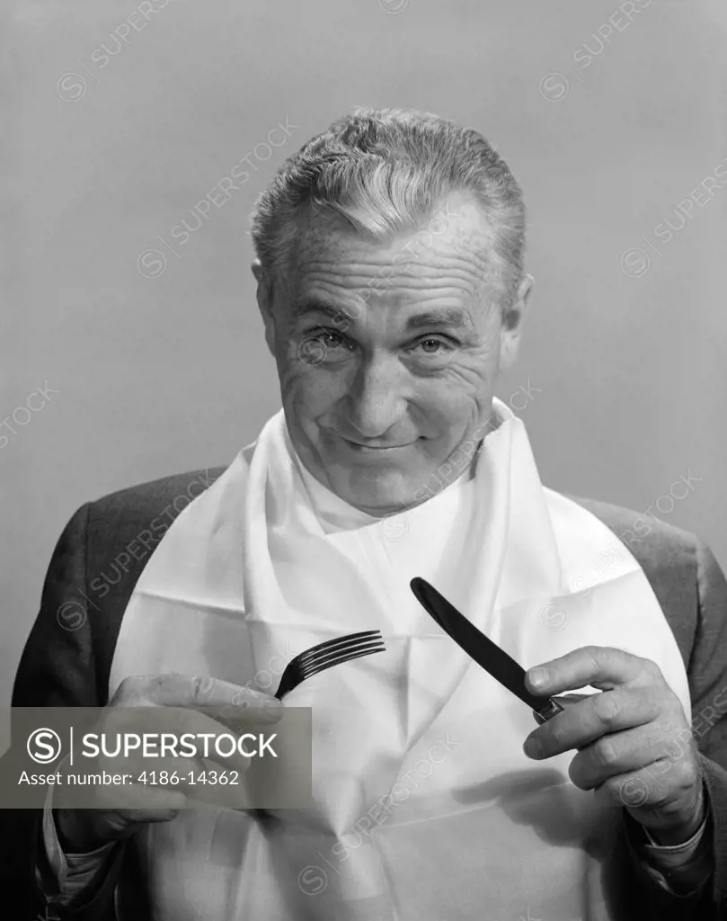 1950S 1960S Elderly Man Wear Napkin As Bib Smiling Holding Knife & Fork Eat Dine Anticipation Food Diet Nutrition