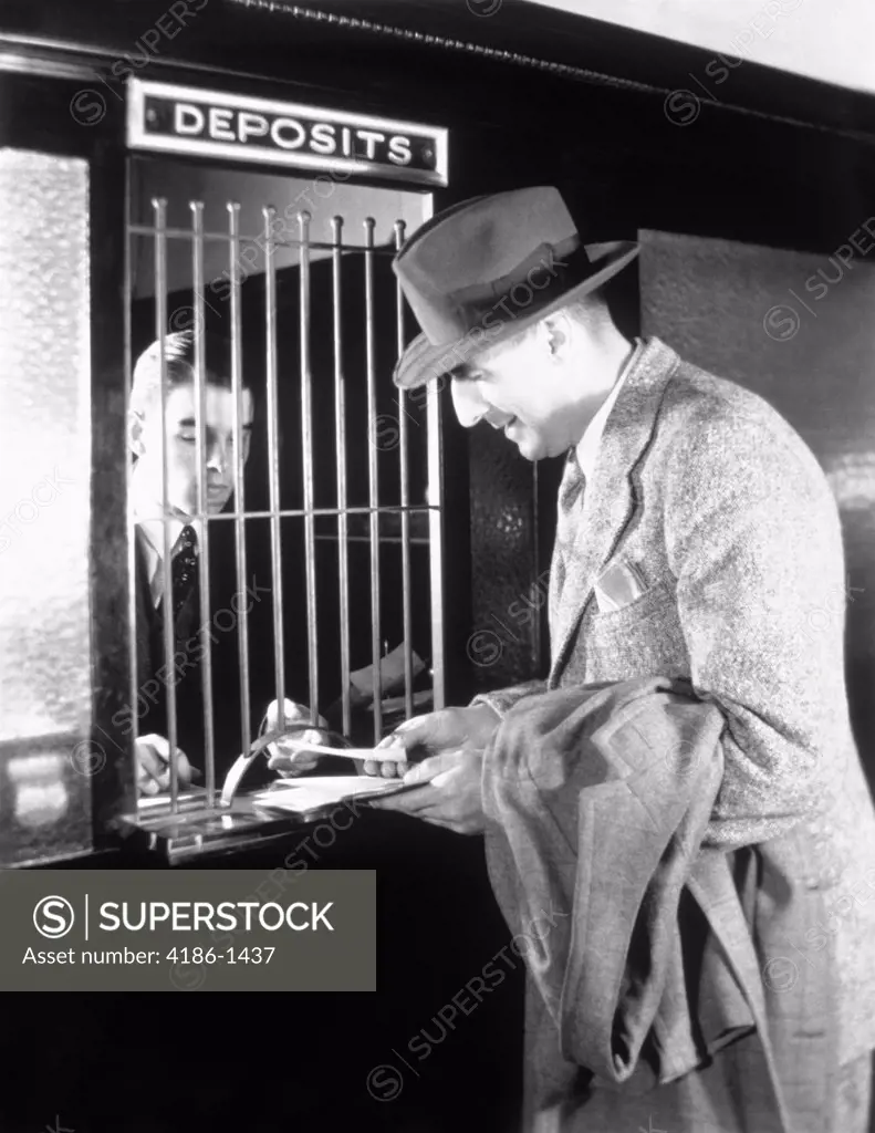 1940S Man At Tellers Window Of Bank Making A Deposit Or Withdrawal