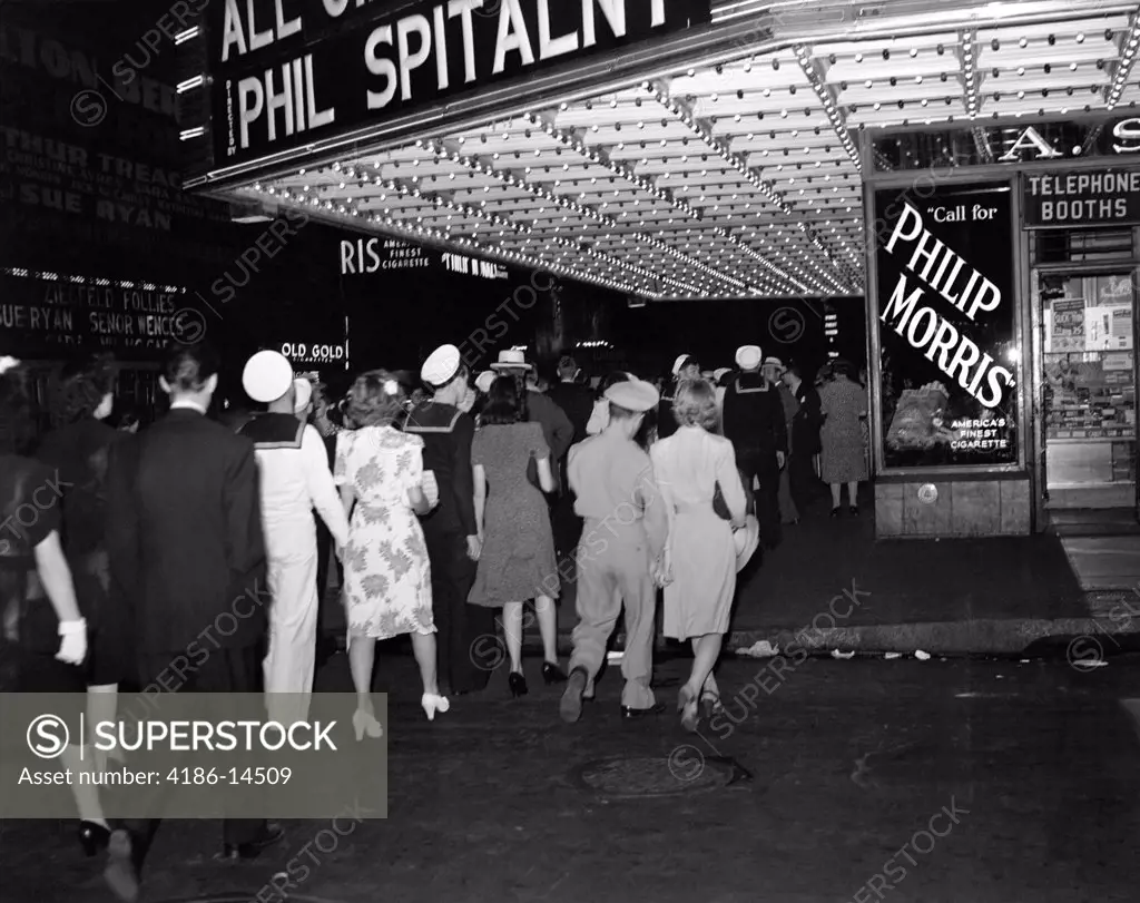 1940S Nyc Broadway At Night Marquee Of Movie Theater With Soldiers Sailors And Women On The Sidewalk Of West 51St Street New York City Usa